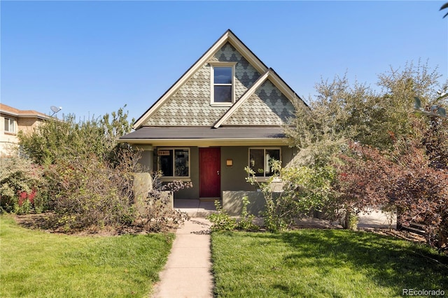 view of front of home with a front lawn and stucco siding