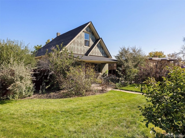 view of side of property with a lawn