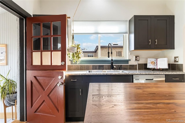 kitchen with dishwasher, butcher block counters, and a sink