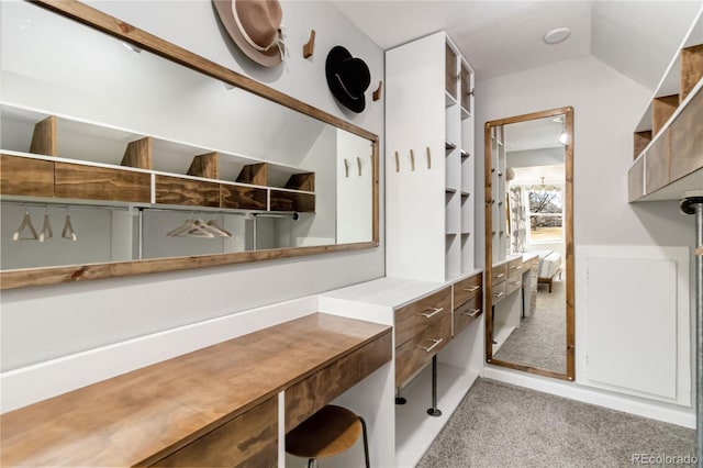 mudroom featuring light carpet and vaulted ceiling