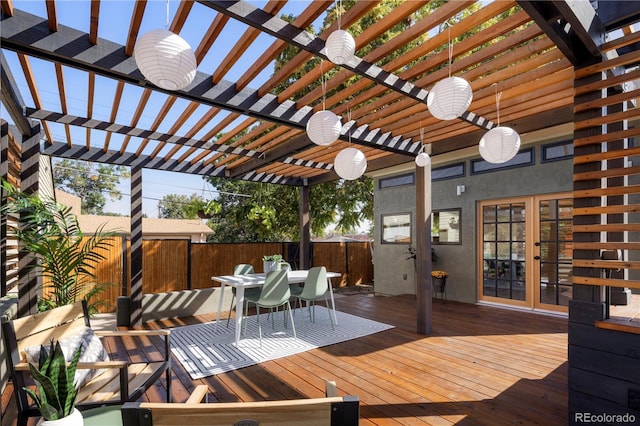 deck featuring outdoor dining area, fence, french doors, and a pergola