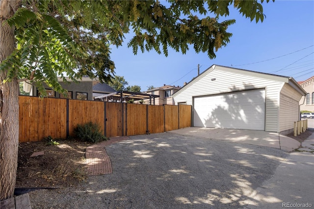 detached garage featuring fence