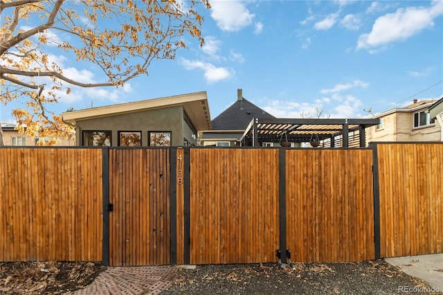 view of gate featuring fence private yard and a pergola