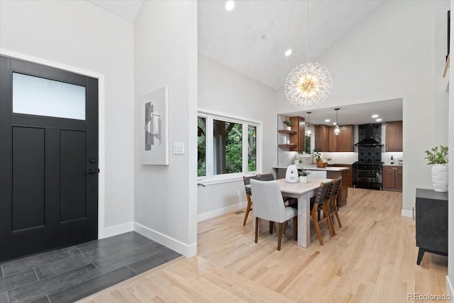 4505 S Yosemite St Unit 362, Denver, CO 80237 - dining area with high vaulted ceiling, a chandelier, light wood-type flooring, baseboards, and recessed lighting