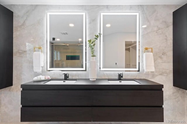 4505 S Yosemite St Unit 362, Denver, CO 80237 - bathroom with tile walls, double vanity, and a shower stall