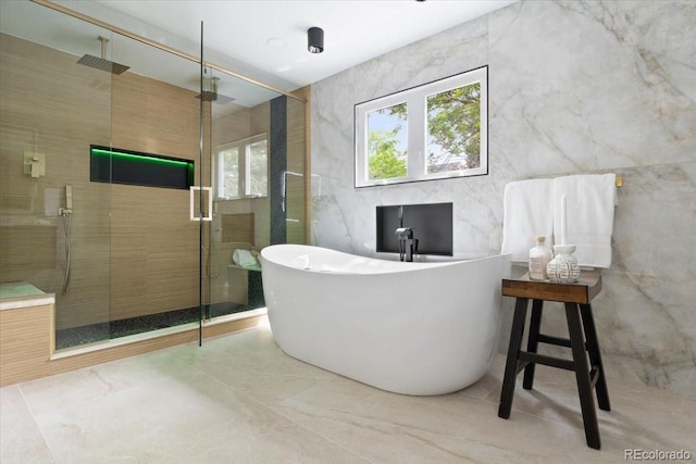 4505 S Yosemite St Unit 362, Denver, CO 80237 - bathroom with a stall shower, a soaking tub, plenty of natural light, tile walls, and marble finish floors