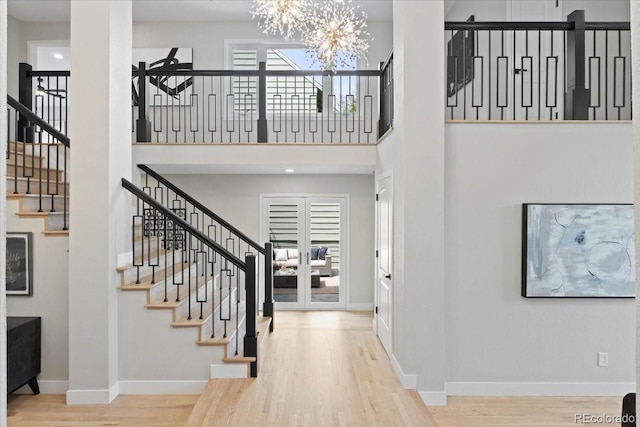 4505 S Yosemite St Unit 362, Denver, CO 80237 - foyer entrance with stairway, wood finished floors, baseboards, a chandelier, and a high ceiling