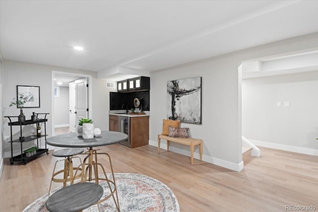 4505 S Yosemite St Unit 362, Denver, CO 80237 - dining area with wet bar, light wood-style floors, beverage cooler, baseboards, and recessed lighting