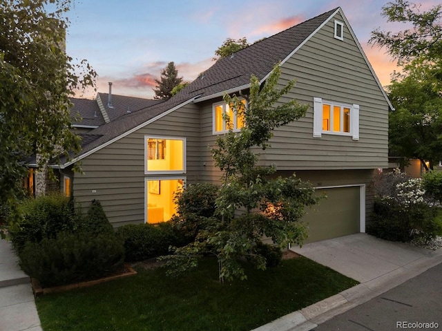4505 S Yosemite St Unit 362, Denver, CO 80237 - property exterior at dusk featuring an attached garage and driveway