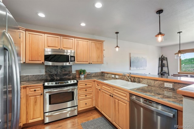 113 Lookout Ridge Dr, Dillon, CO 80435 - kitchen featuring appliances with stainless steel finishes, tile countertops, a peninsula, light wood-type flooring, and recessed lighting