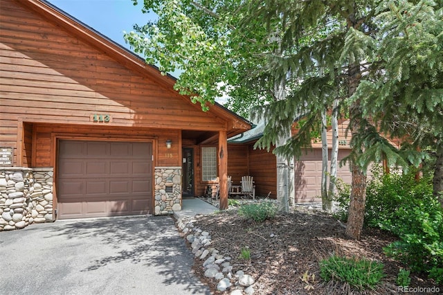 113 Lookout Ridge Dr, Dillon, CO 80435 - doorway to property featuring stone siding and asphalt driveway