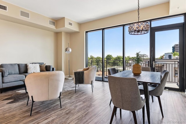 dining space with hardwood / wood-style floors