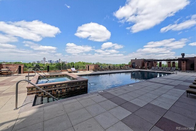 view of pool featuring a community hot tub and a patio area