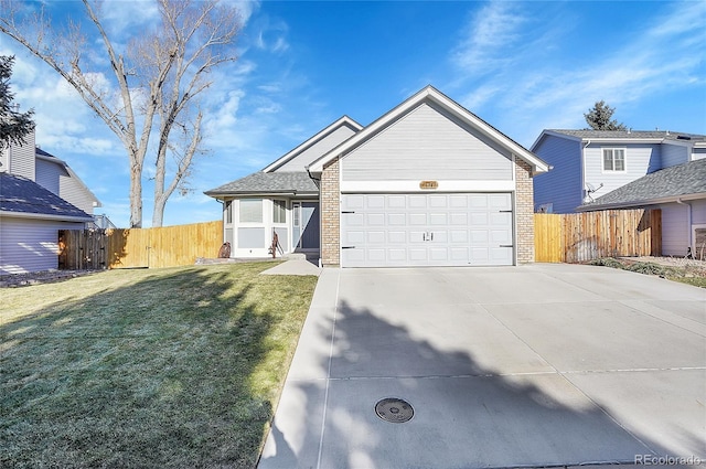 single story home featuring a garage, a front lawn, concrete driveway, and brick siding