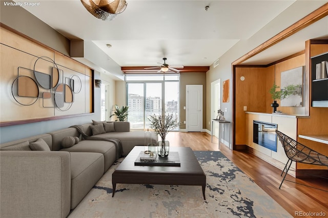 living room with ceiling fan and light hardwood / wood-style flooring