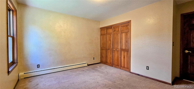 18170 Forest View Rd, Monument, CO 80132 - unfurnished bedroom featuring baseboard heating, carpet floors, a closet, a textured wall, and baseboards