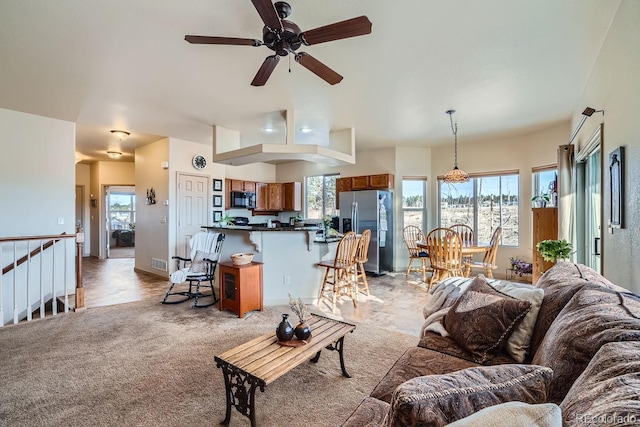 living room featuring light carpet and ceiling fan