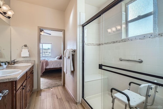 bathroom with ceiling fan, an enclosed shower, and vanity