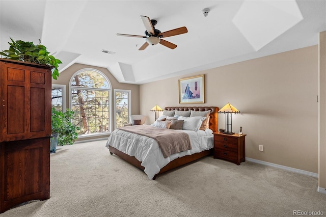 bedroom featuring light carpet, vaulted ceiling, visible vents, and baseboards