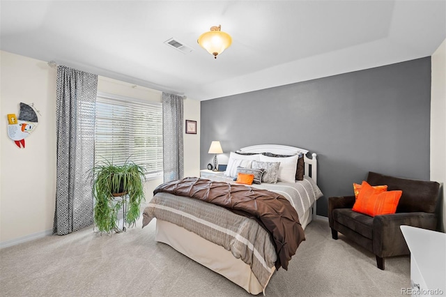 carpeted bedroom with visible vents and baseboards