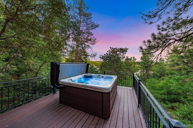 deck at dusk with a hot tub