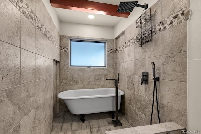 bathroom featuring a washtub and hardwood / wood-style flooring