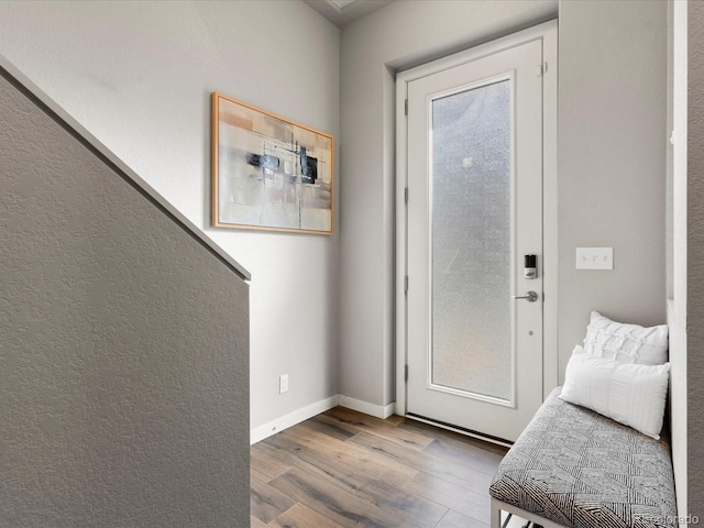 entryway featuring wood finished floors and baseboards