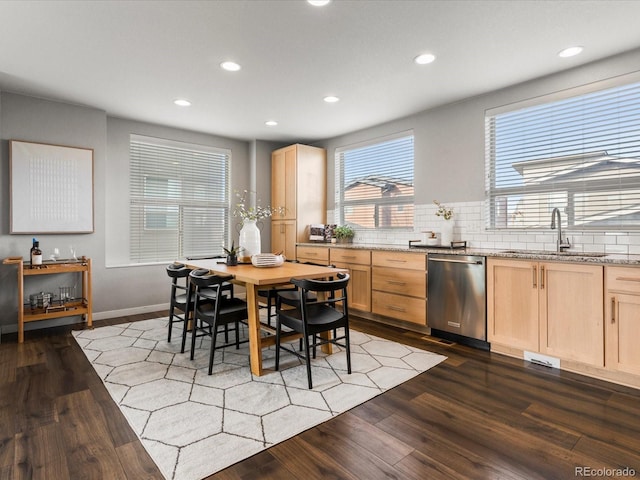 kitchen featuring a sink, dishwasher, wood finished floors, and light brown cabinets