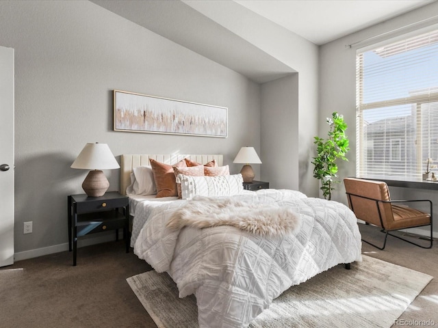 carpeted bedroom featuring baseboards