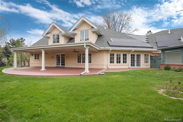 back of property featuring a patio area, a yard, french doors, and stucco siding