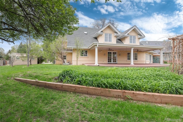 view of front of property with a front yard, ceiling fan, and stucco siding