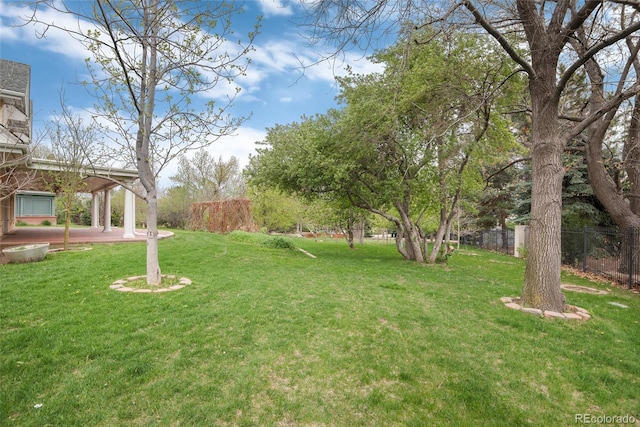 view of yard featuring fence and a patio