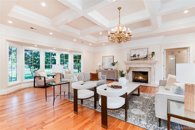 living room with a wealth of natural light, visible vents, and light wood-style flooring