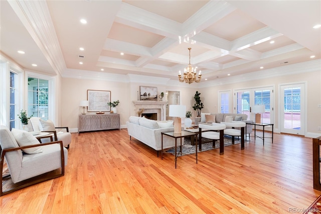 living area with light wood finished floors, coffered ceiling, ornamental molding, beamed ceiling, and a fireplace