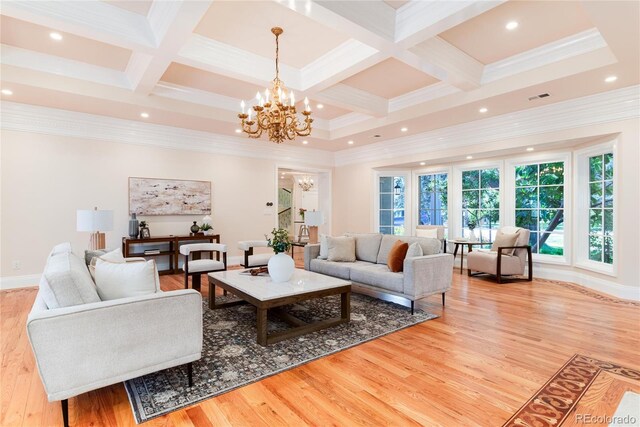 living room with light wood finished floors, a chandelier, coffered ceiling, and beam ceiling