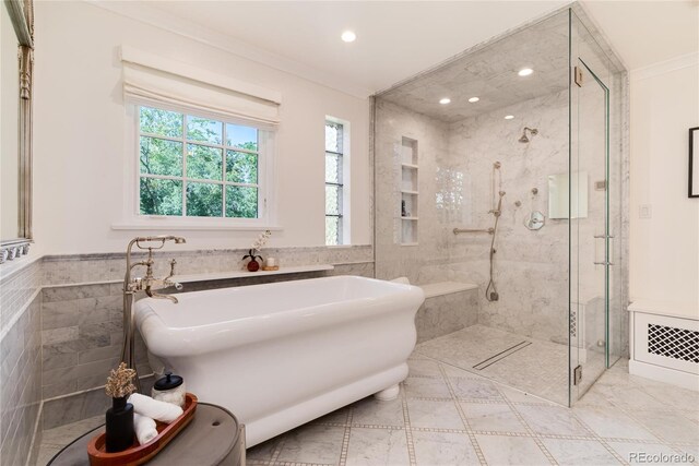 full bath with ornamental molding, a stall shower, and tile walls