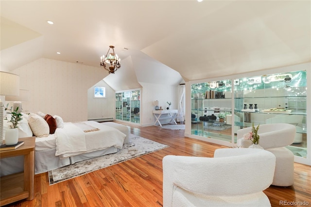 bedroom featuring light wood-type flooring, a baseboard radiator, a chandelier, and vaulted ceiling