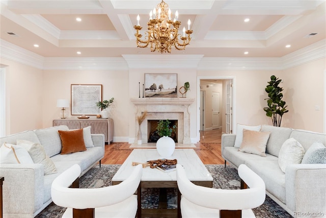 living room with light wood-type flooring, a premium fireplace, and coffered ceiling