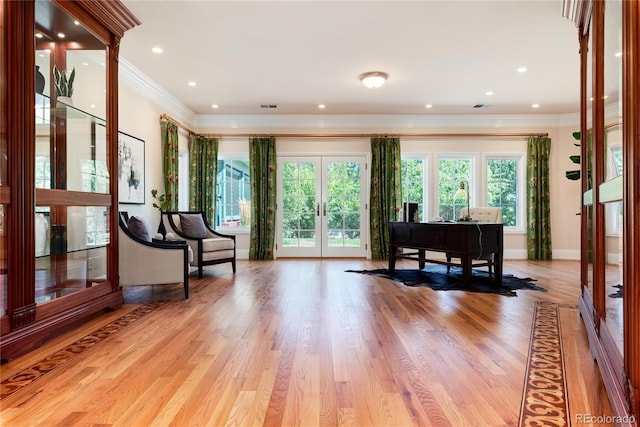 sitting room featuring light wood finished floors, baseboards, crown molding, french doors, and recessed lighting