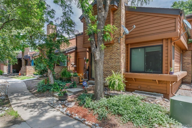 2685 S Dayton Way Unit 253, Denver, CO 80231 - view of front facade with brick siding and a chimney