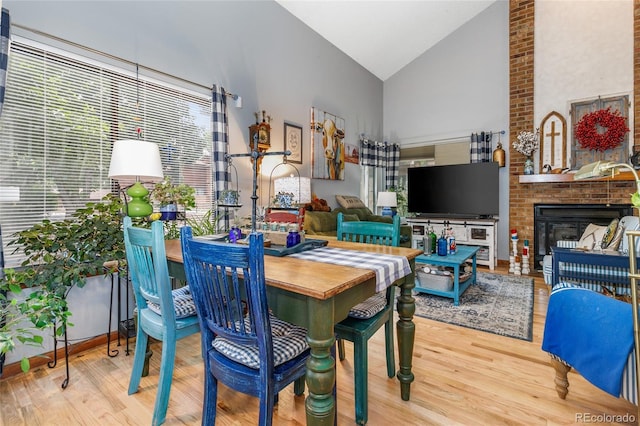 2685 S Dayton Way Unit 253, Denver, CO 80231 - dining room with high vaulted ceiling, wood finished floors, and a brick fireplace