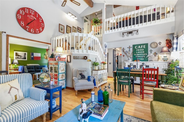 2685 S Dayton Way Unit 253, Denver, CO 80231 - living room with high vaulted ceiling, wood finished floors, stairway, beam ceiling, and ceiling fan
