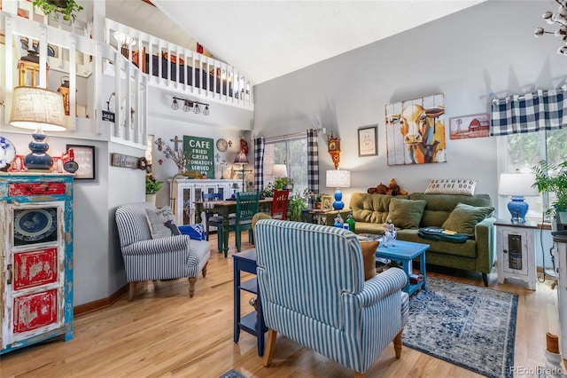2685 S Dayton Way Unit 253, Denver, CO 80231 - living room featuring healthy amount of natural light, wood finished floors, and high vaulted ceiling