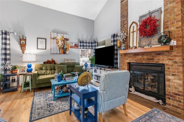 2685 S Dayton Way Unit 253, Denver, CO 80231 - living room with high vaulted ceiling, wood finished floors, and a fireplace
