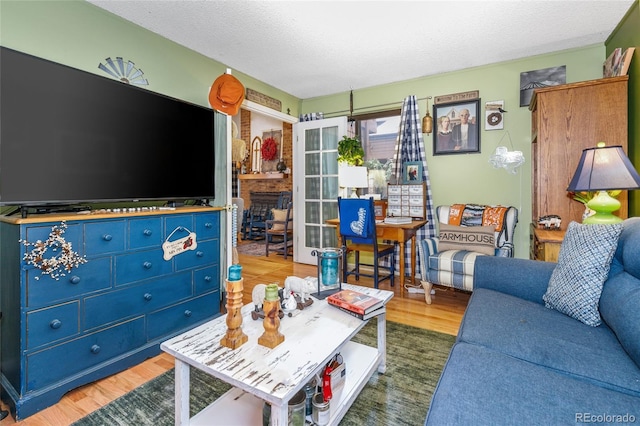 2685 S Dayton Way Unit 253, Denver, CO 80231 - living area with wood finished floors and a textured ceiling