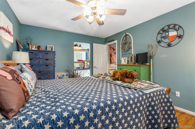 2685 S Dayton Way Unit 253, Denver, CO 80231 - bedroom with wood finished floors, a textured ceiling, and ceiling fan