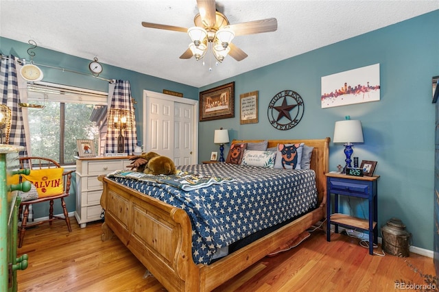 2685 S Dayton Way Unit 253, Denver, CO 80231 - bedroom with light wood finished floors, a closet, a textured ceiling, and ceiling fan
