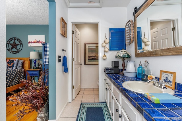 2685 S Dayton Way Unit 253, Denver, CO 80231 - bathroom featuring vanity, tile patterned floors, and a textured ceiling