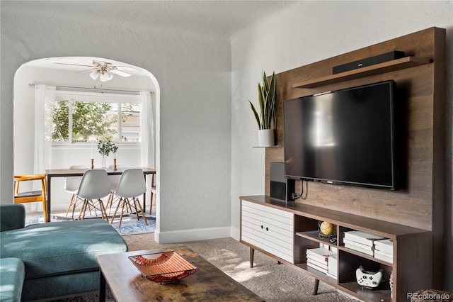 60 Vrain St, Denver, CO 80219 - living area featuring carpet floors, ceiling fan, arched walkways, and a textured wall