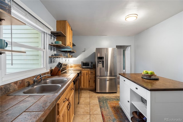 60 Vrain St, Denver, CO 80219 - kitchen with appliances with stainless steel finishes, open shelves, light tile patterned floors, ventilation hood, and brown cabinets